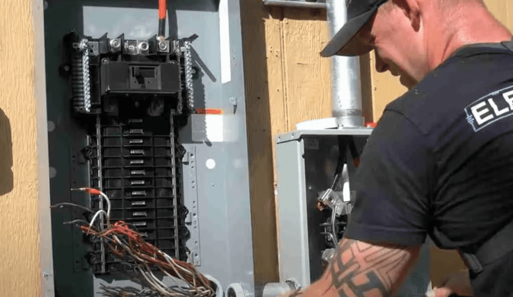 Dustin working in an electrical service panel